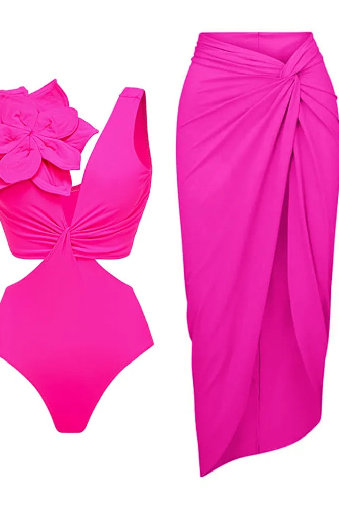 Pink swimsuit with cut out side detailing & a 3d black large flower applique featured on the shoulder. Matched with a Pink knot slit detail midi-maxi skirt 