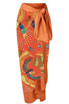 Beatrice Printed Tie Knot Beach Sarong | Beach Skirt In shade orange, featuring a orange, yellow, blue and green leaf abstract feather print