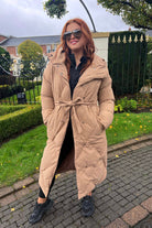 Oversized Long Tie Waist Duvet Coat in Camel. Wrap yourself in warmth and style with our Oversized Long Tie Waist Duvet Coat in Camel. The top to bottom button fasteners and removable tie around belt offer convenience and versatility.